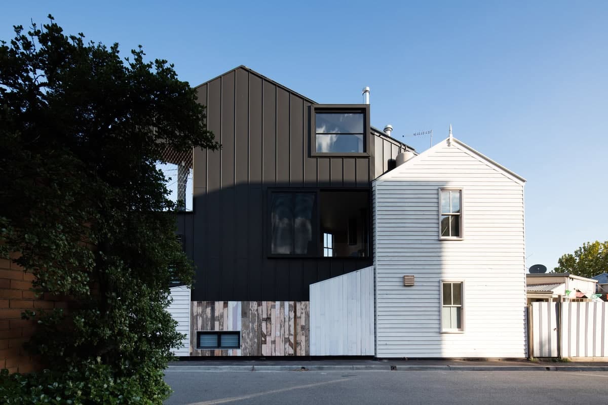 Striking blend of modern and traditional architecture highlighted by contrasting dark and white façades.