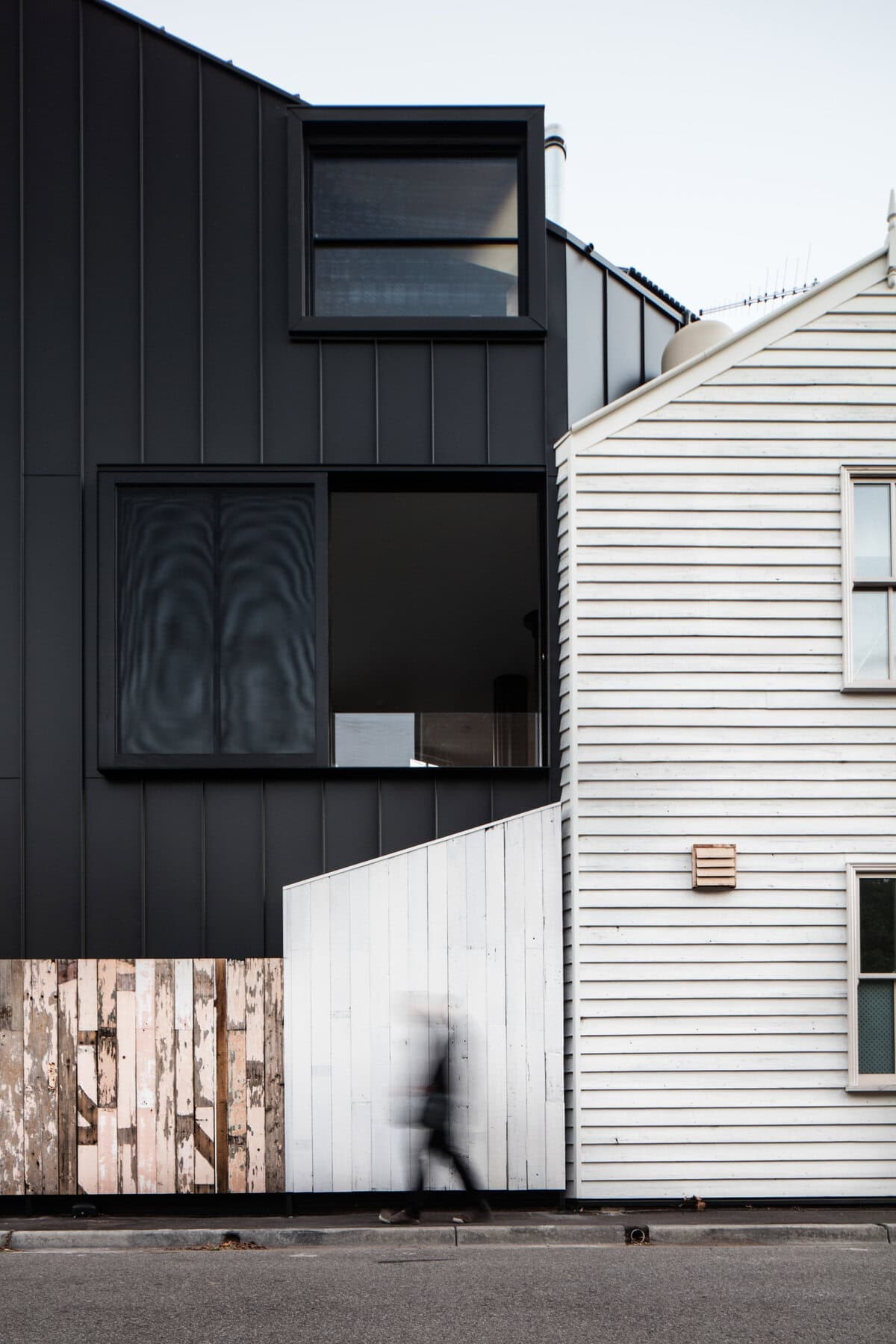 Architectural contrast showcasing modern and traditional homes in a vibrant urban setting.