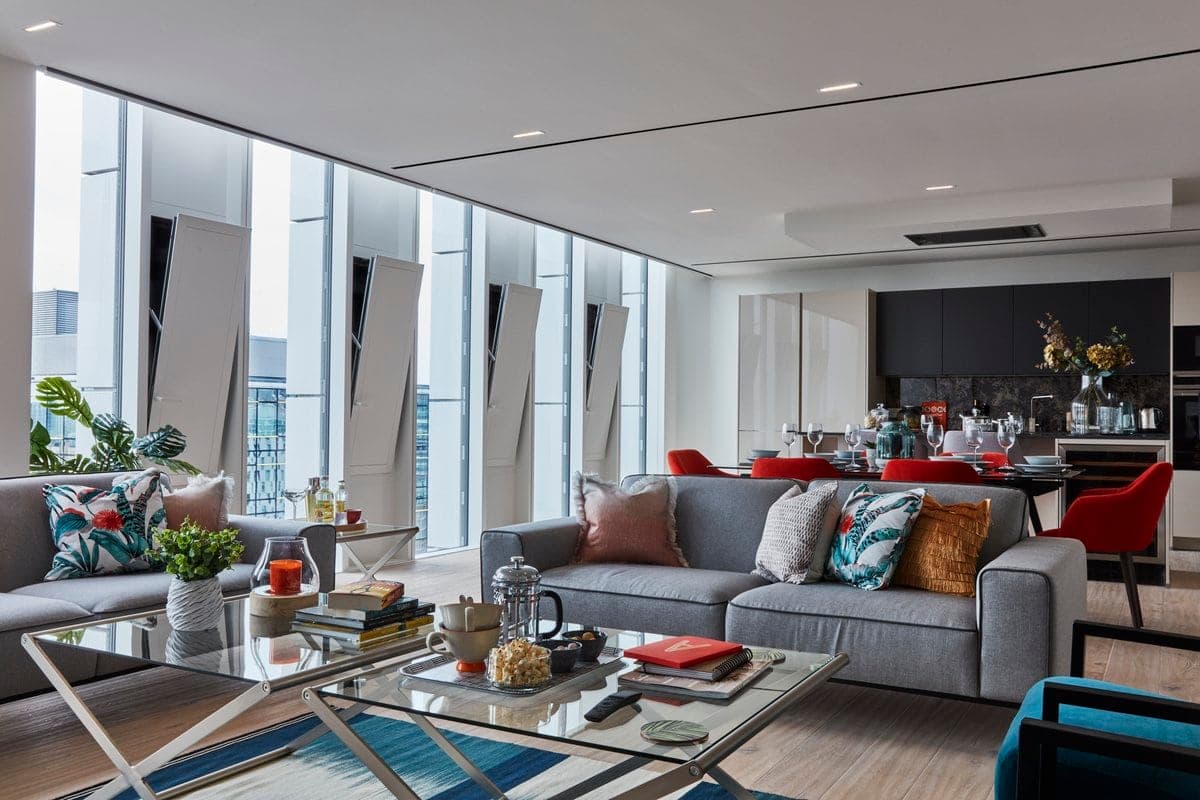 Modern open-plan living and dining area with chic décor and urban views.