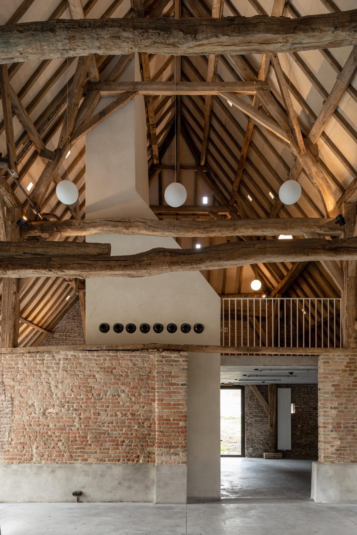 Charming rustic modern barn interior featuring exposed beams and inviting brick accents.