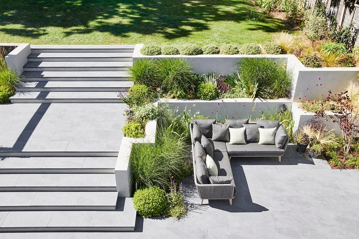 Stylish outdoor retreat with modern seating and lush landscaping for relaxation and gatherings.