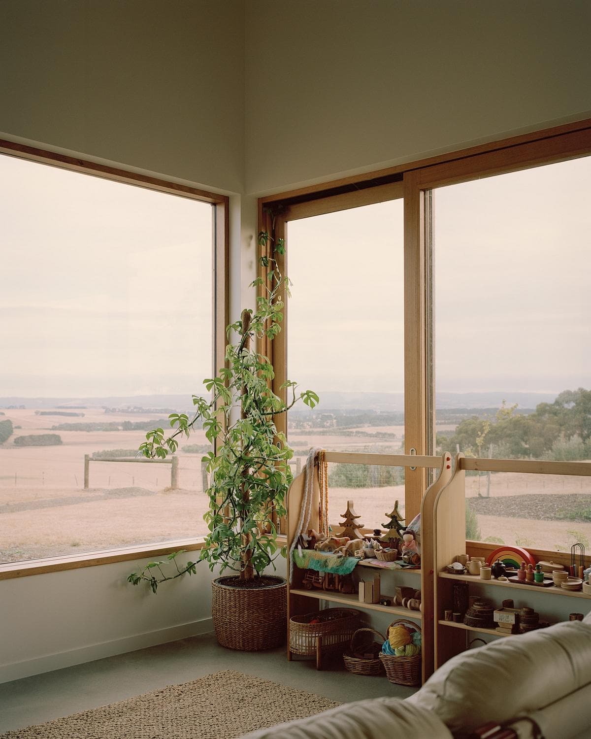 Tranquil interior with panoramic windows, greenery, and a cozy seating area for relaxation.