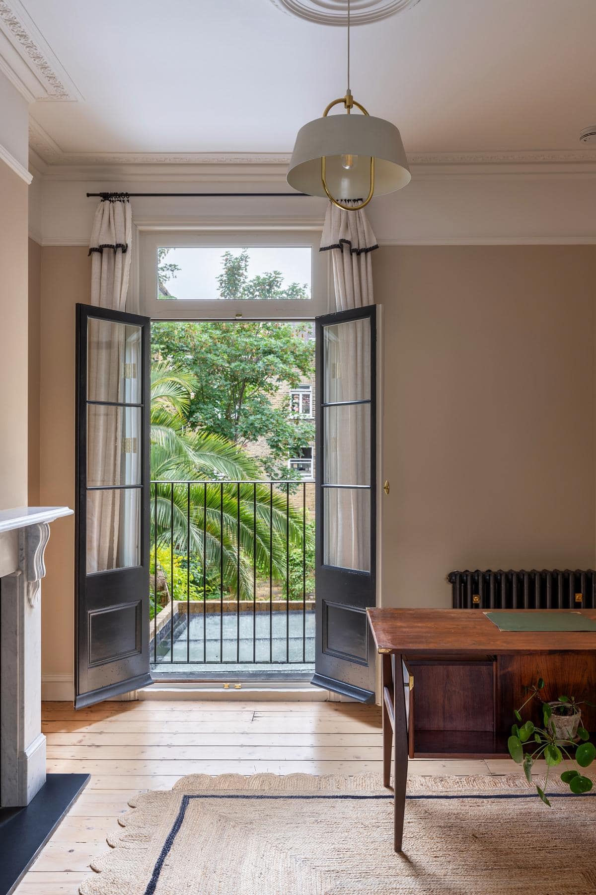 Tranquil interior featuring elegant French doors and a charming garden view.
