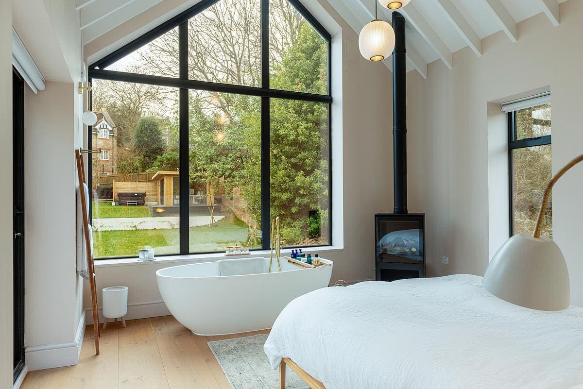Tranquil modern bedroom and bathroom space with natural light and seamless interior design.