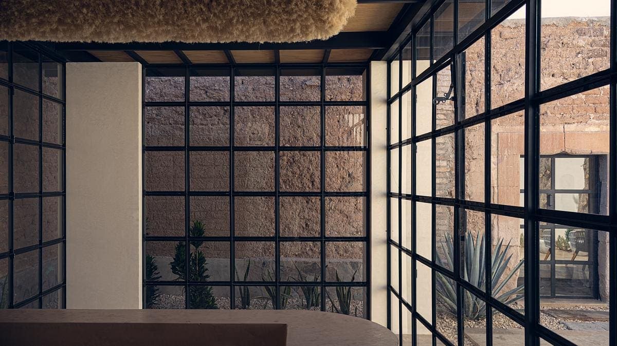 Stylish modern interior with garden view, blending natural light and rustic charm.