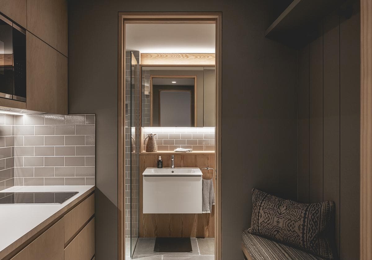 Contemporary bathroom oasis featuring a sleek kitchenette and minimalist design elements.