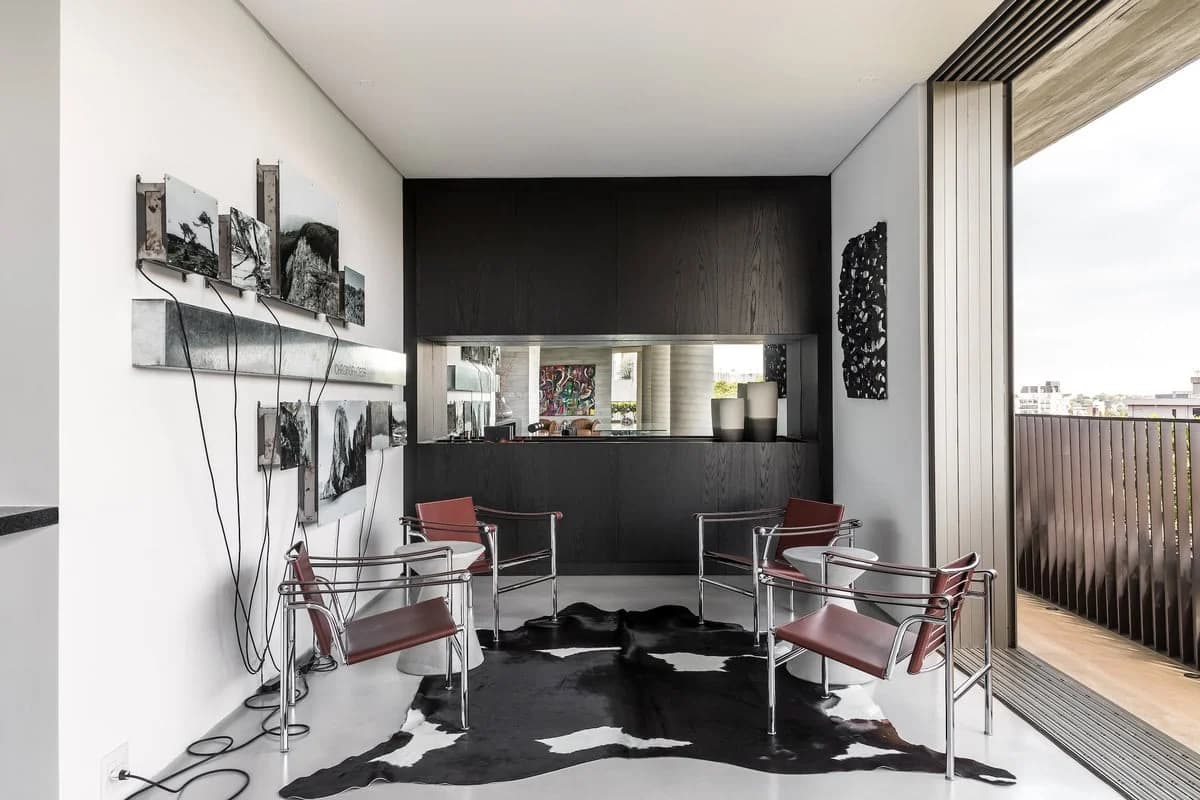 Modern minimalist living space with light, dark accents, and seamless indoor-outdoor flow.