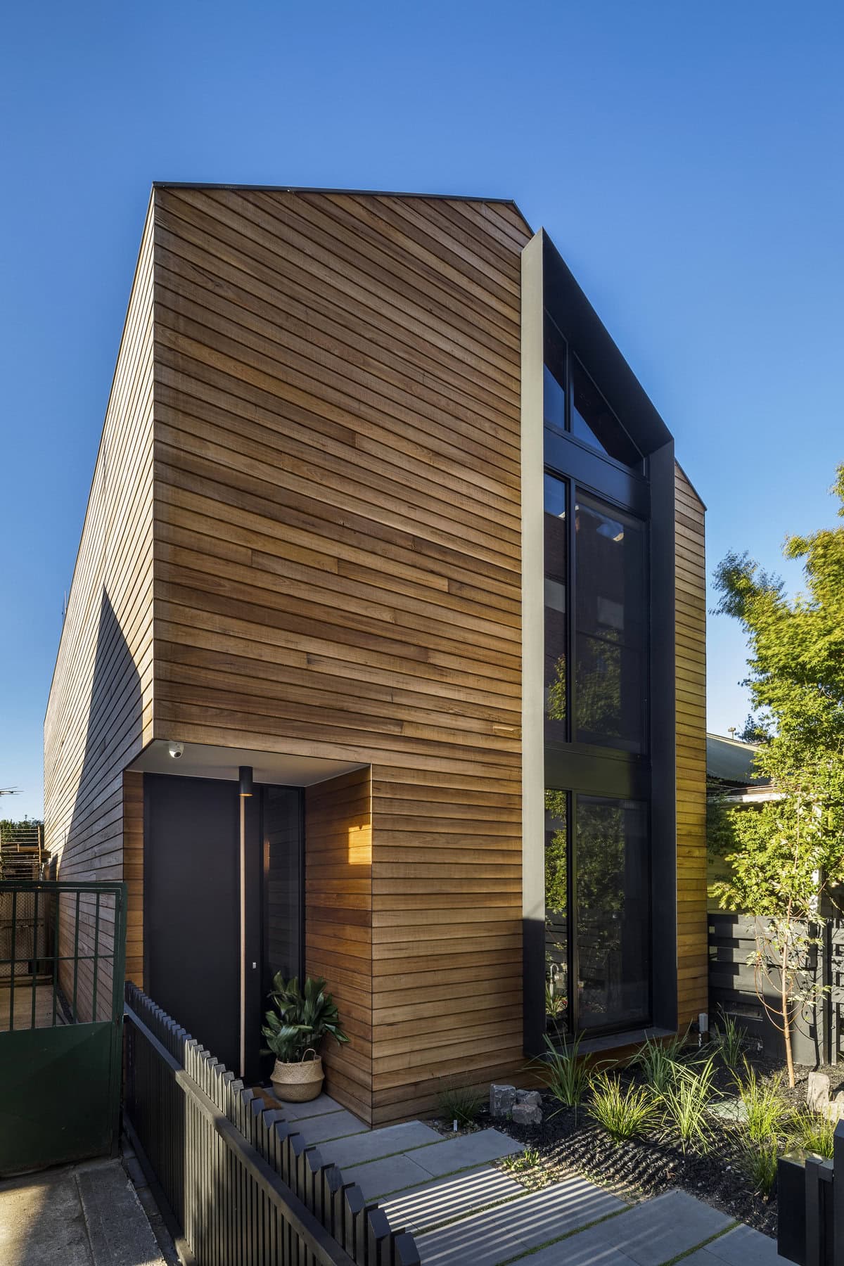 Sleek modern architecture featuring wood cladding and minimalist landscaping at Tanner St.