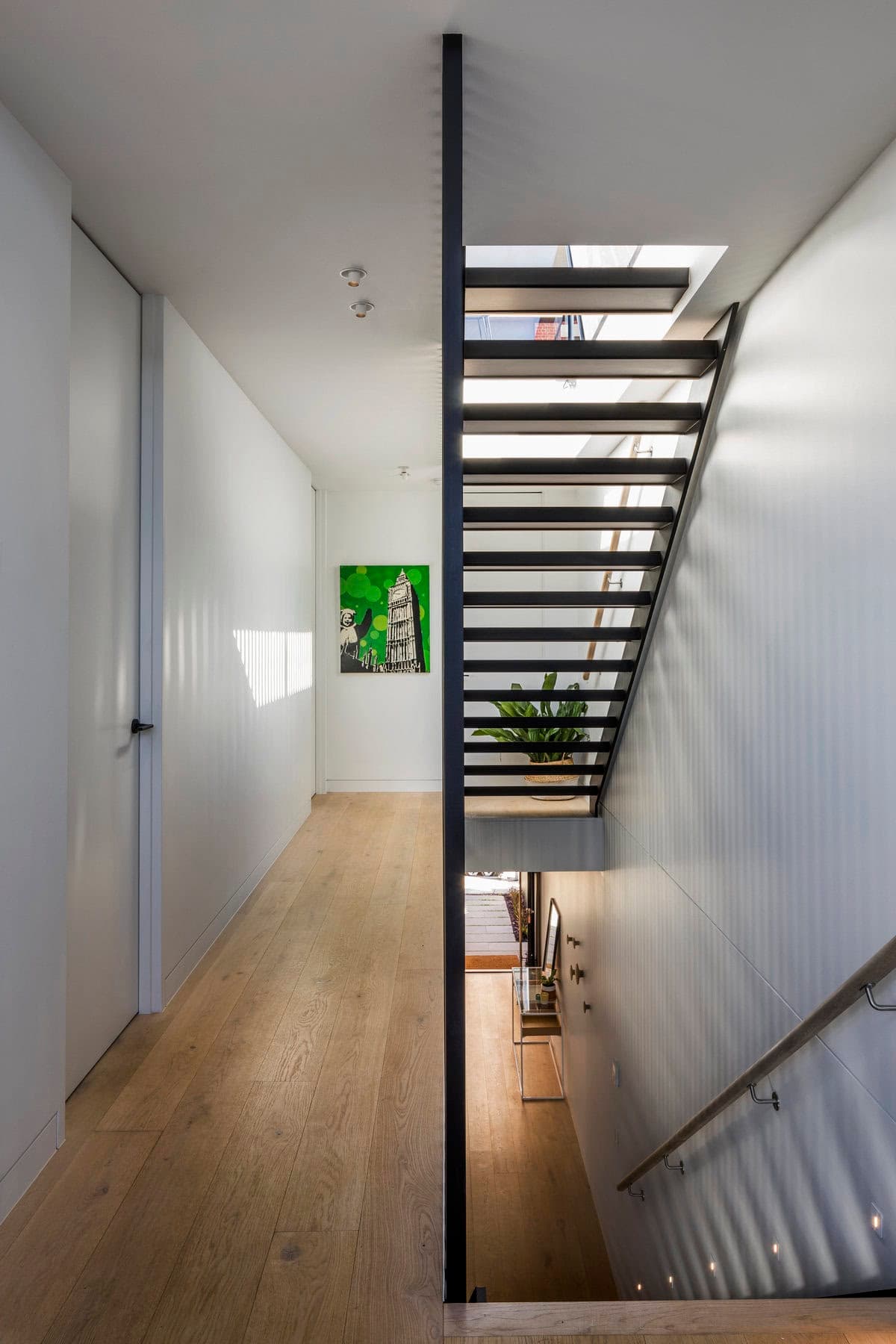 Sleek minimalist staircase in a bright, modern interior by FYC Architects.