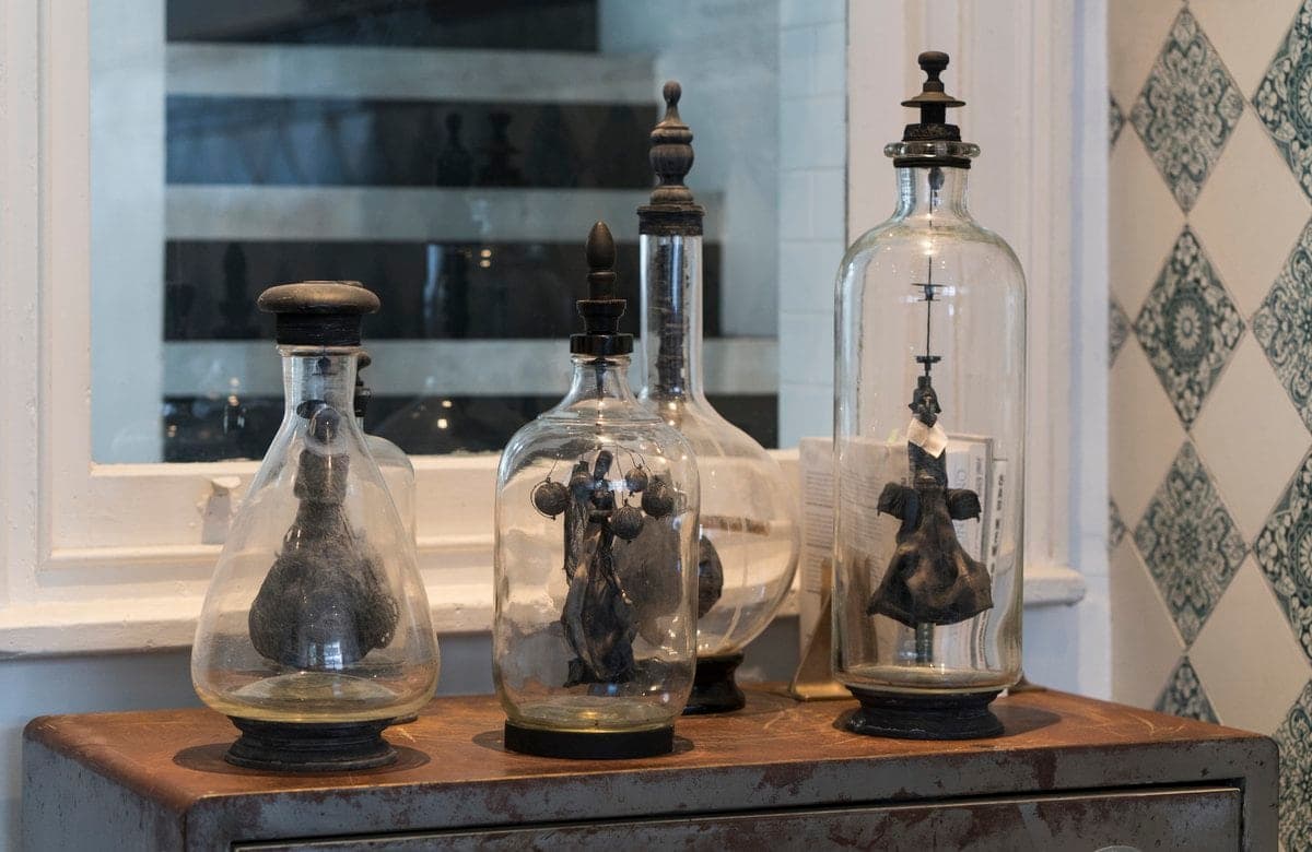 Vintage laboratory glassware with bell jars and metallic mechanisms in a nostalgic scientific setting.