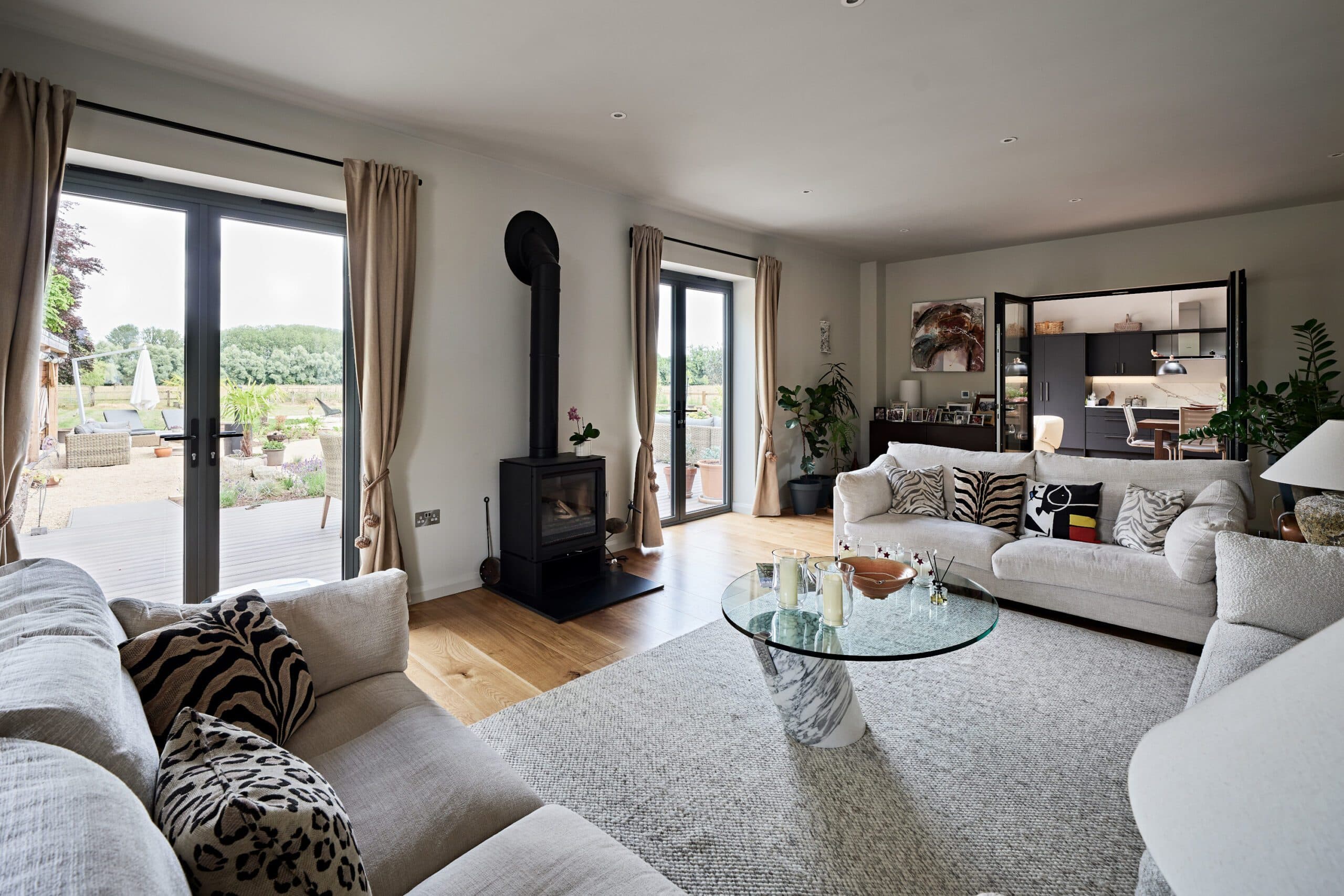 Sitting room with a wood-burning stove and glazed doors to the terrace