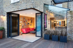 Hennessey House by Paul Archer Design — fully retractable glass doors opening living area to garden