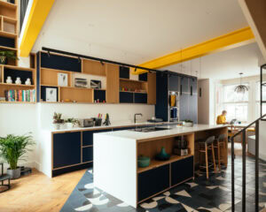 Preston Drove kitchen with traffic yellow structural beams by Life Size Architecture
