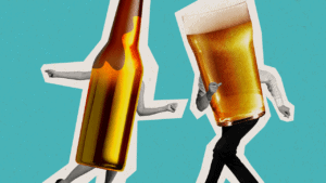 Playful beer bottle and glass dancing on a bright turquoise background.
