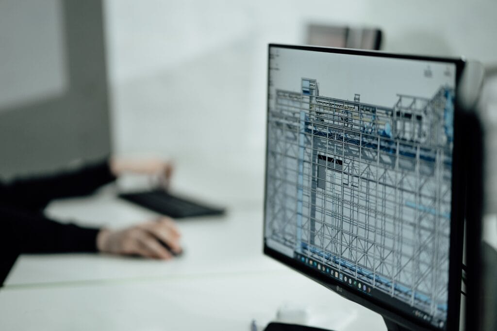 Architect working on a detailed blueprint using CAD software.