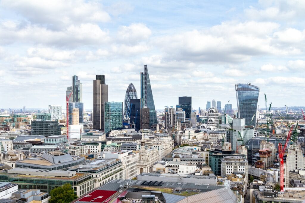 Bustling cityscape with diverse architecture under a partly cloudy sky.