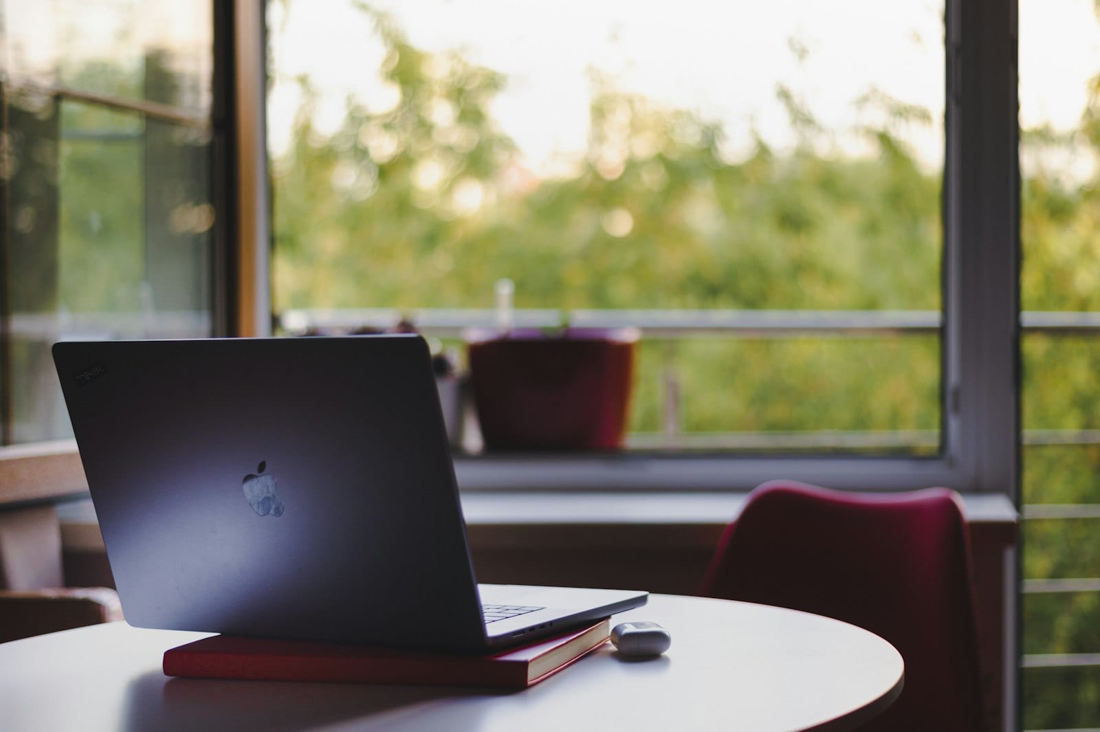 Minimalist clean white desk with a single open laptop ready for writing