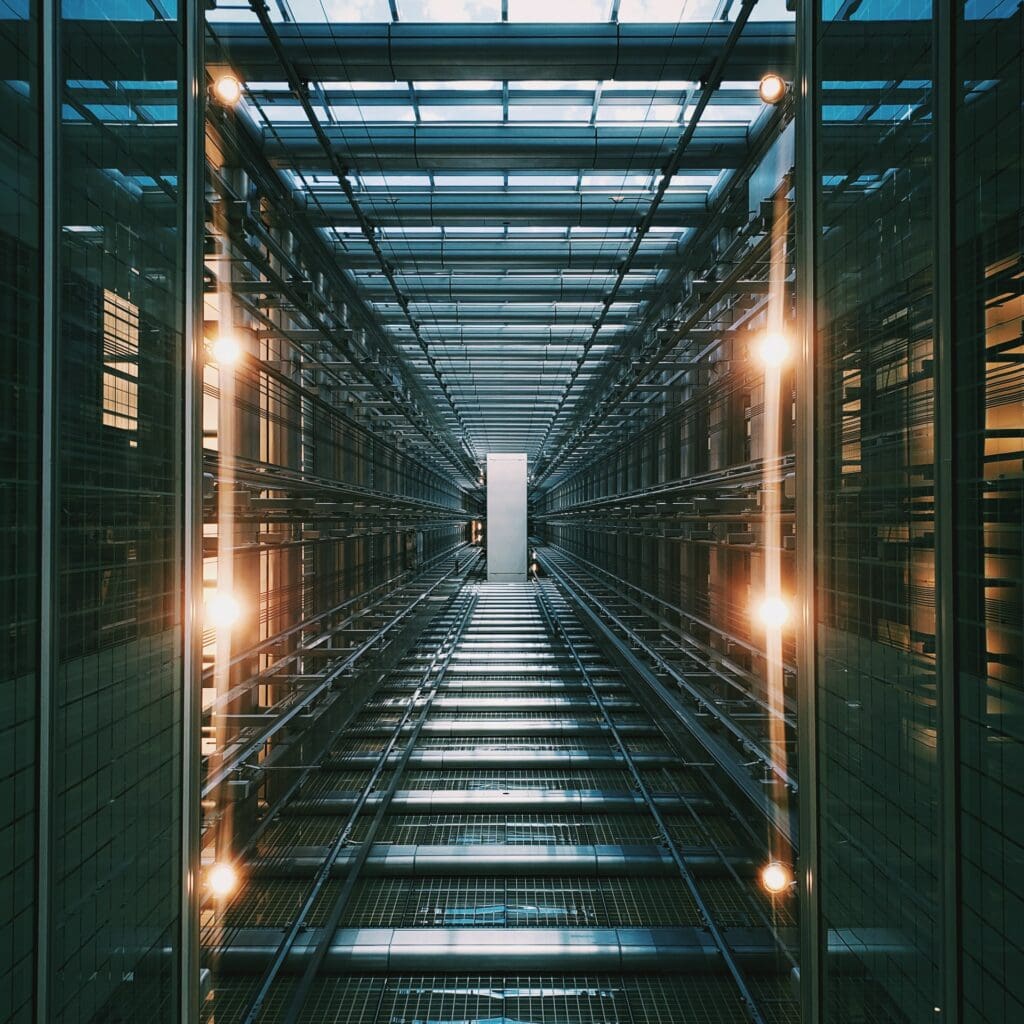Futuristic data center corridor with sleek server racks, controlled lighting, and a bright focal point.