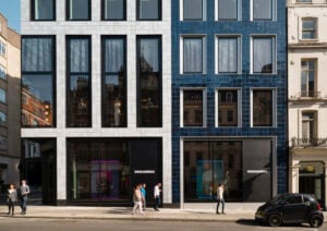 Modern facade with large windows, Dolce & Gabbana storefront, bustling city street.