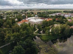 Aerial view of a historic landmark surrounded by lush gardens and serene water features.