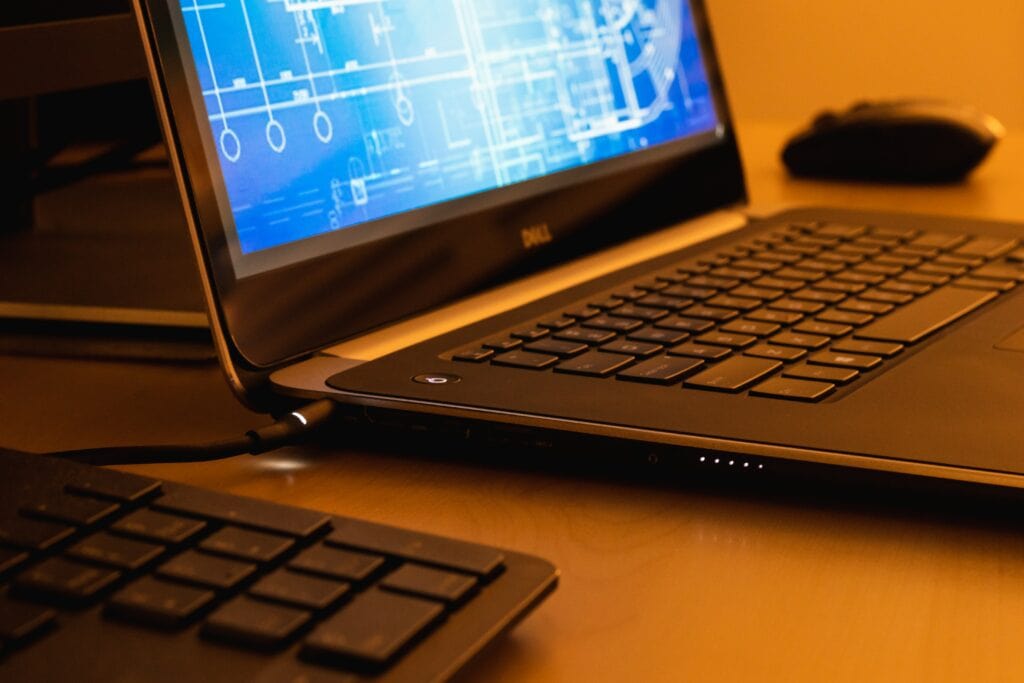 Close-up of a laptop with a technical drawing on the screen.