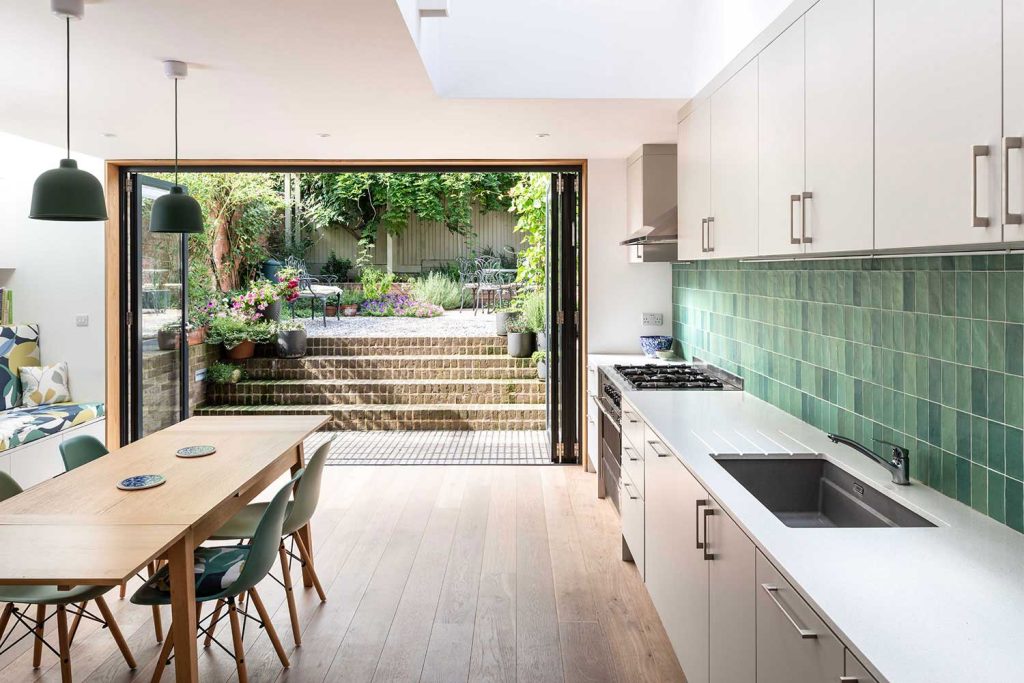 Contemporary kitchen and dining area seamlessly flowing into a lush garden retreat.
