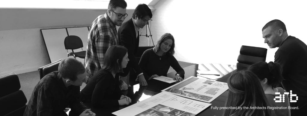 Dynamic team collaboration in a modern workspace focused on brainstorming and project review.