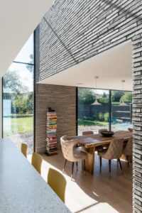Long Brick House open plan kitchen with garden views by Bradley Van Der Straeten