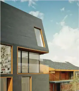 Modern dark and light wood buildings with unique windows, designed by Owen Design Studio.
