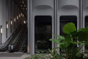 Modern indoor architecture with escalators, glass façade, and greenery blending urban design and nature.