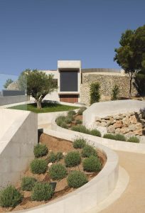 Contemporary architecture blending seamlessly with nature, featuring sustainable design and lush landscaping.