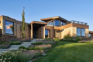 Modern home with a deck, blending contemporary design and natural beauty in serene surroundings.