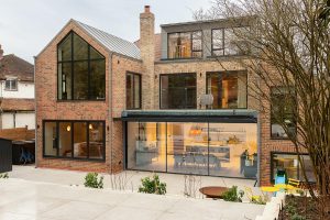 Stylish multi-level home with elegant garden, blending modern architecture and classic brickwork elements.