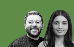 Grayscale man and woman smiling together on a vibrant green background.