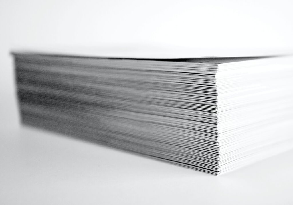 Stack of white paper sheets, neatly aligned with crisp edges.