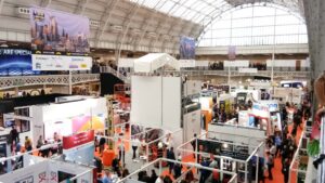 London Build Expo: High-energy trade show with diverse booths, vibrant networking, and airy venue.